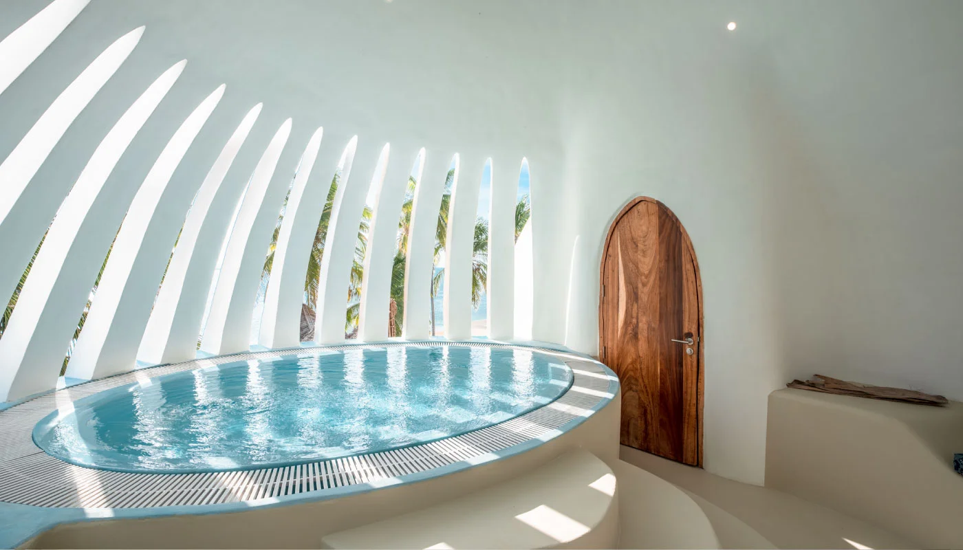 Private rooftop pool at Nyota Villa in Xanadu Luxury Villas & Retreat, Zanzibar, featuring a curved plunge pool, distinctive arched architecture and light-filled ocean views.